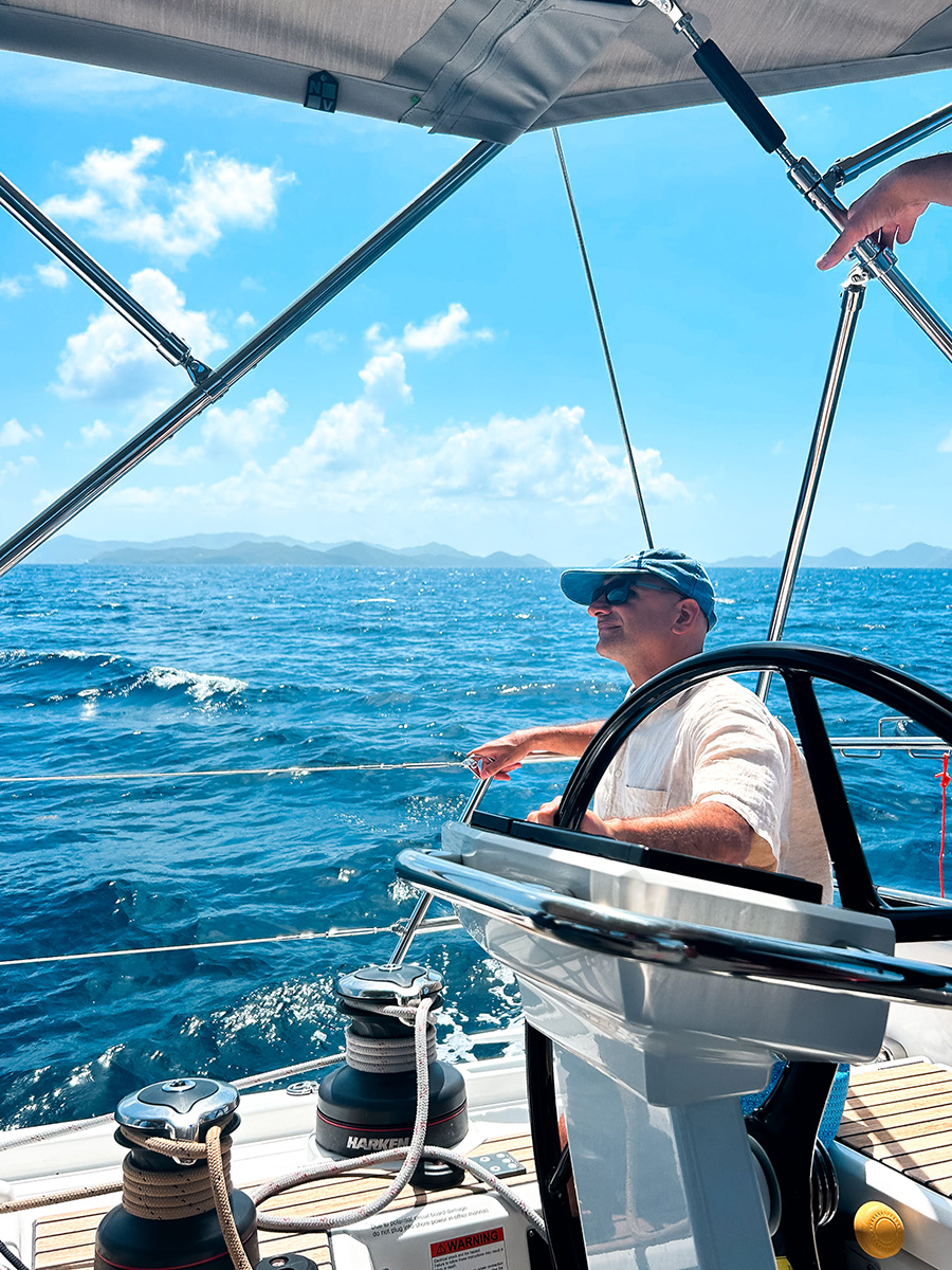 Man in hat, sailing yacht in the ocean