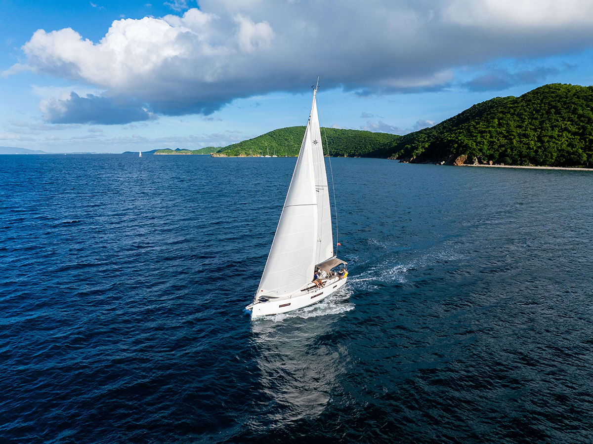 Drone shot of yacht sailing with crew